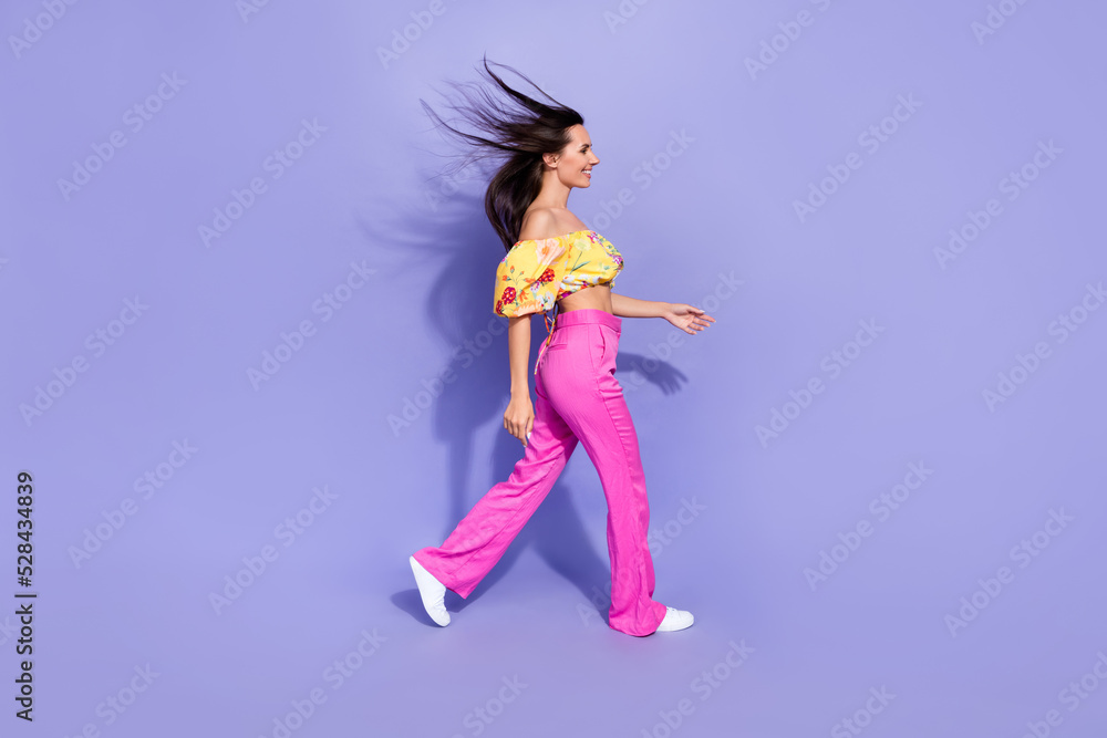 Profile photo of adorable cheerful carefree person walk empty space isolated on violet color background