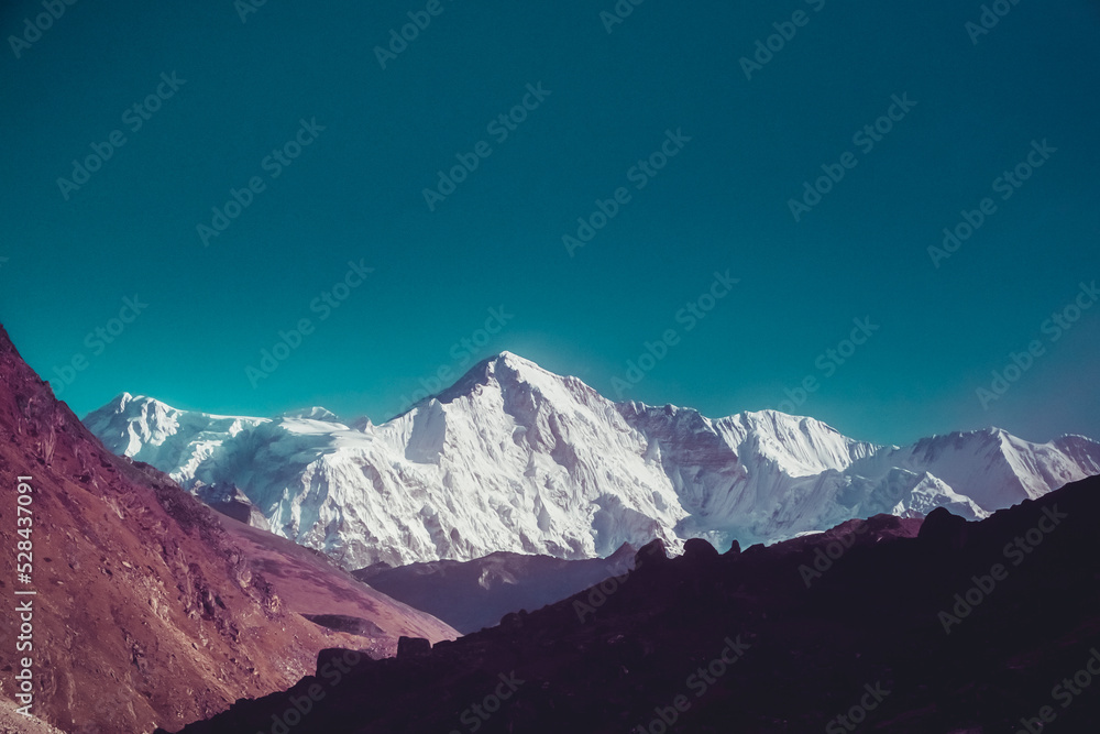 Snowy mountain peak in Himalaya mountain national park. Trekking, sports, active lifestyle. Panoramic landscape nature background. Vintage retro tone filter