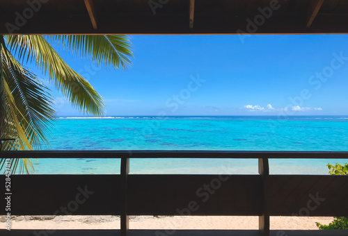 Window to tropical island beach with coconut palm branch, turquoise water and blue sky. Its time to have a vacation concept. Travel tourism background © Anastasia Pro
