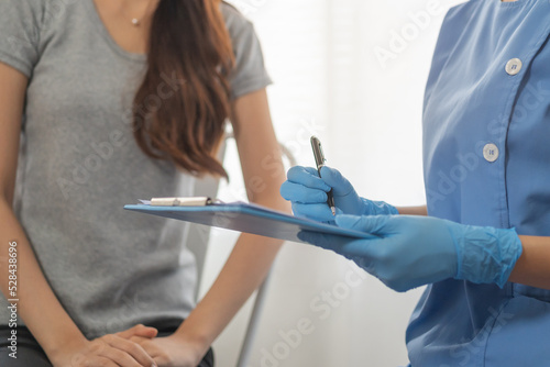 Covid-19, corona asian young woman patient before receive, getting vaccine. Nurse inquire personal information, disease. Vaccination, immunization or disease prevention against flu or virus pandemic.