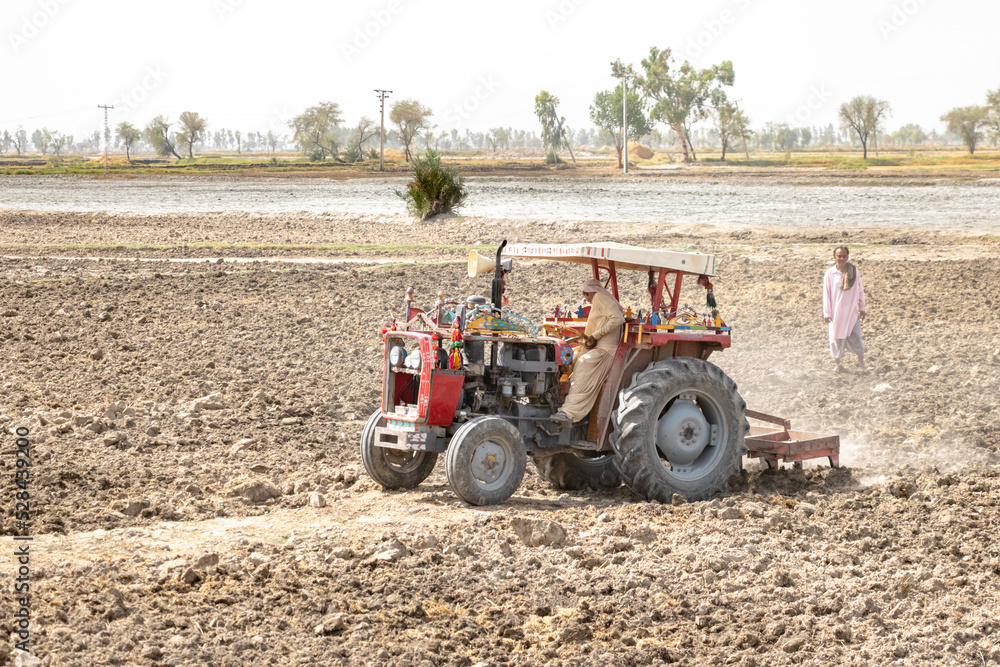 a tractor is digging land and preparing for farming purposes a tractor is digging land and preparing for farming purposes