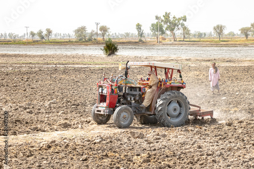 a tractor is digging land and preparing for farming purposes