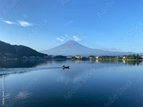 Boat ride across the lake Kawaguchiko with beautiful clear Mt. Fuji view  sunny day with blue sky and the clear tip of the mountain  year 2022 August 27th  6 27am Yamanashi prefecture  Japan 