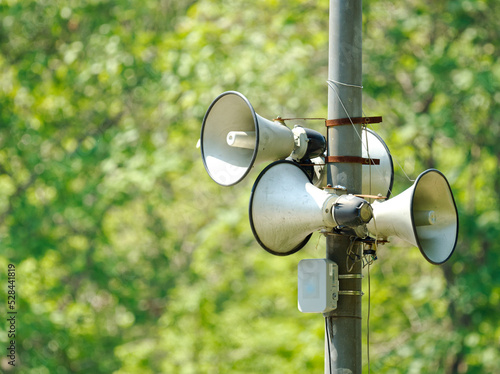 many speaker is mounted on an electric pole
