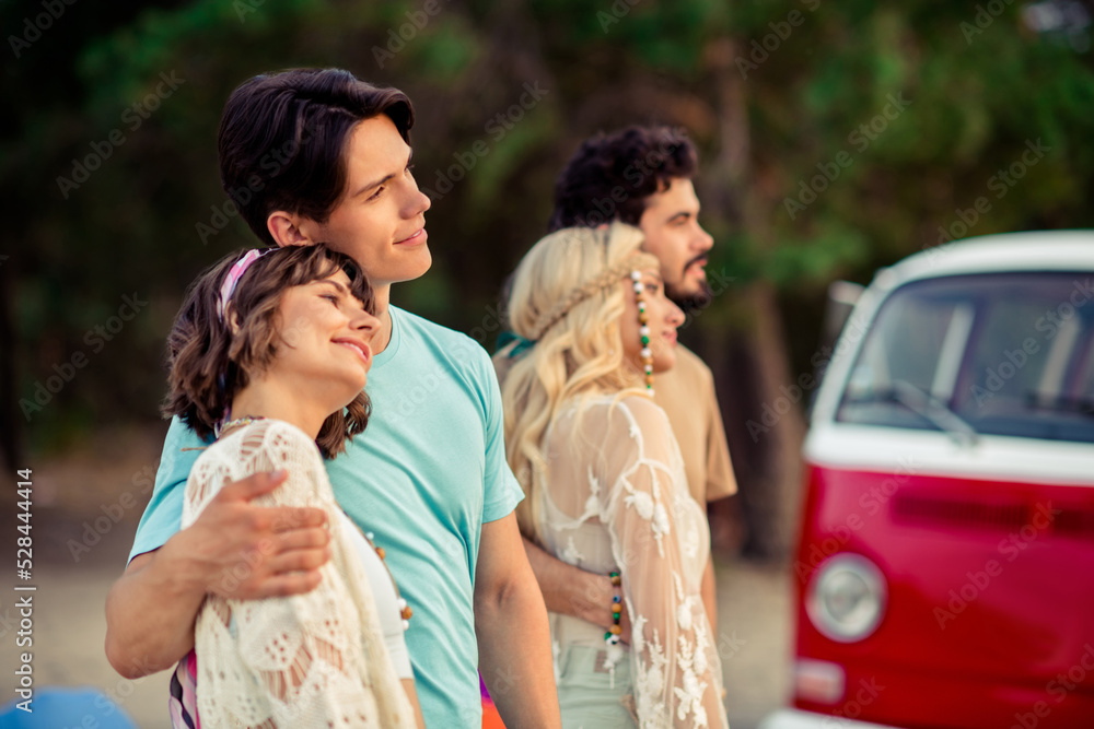 Photo of cheerful positive hippie people company cuddling together enjoying sunset outside seaside beach Photo of cheerful positive hippie people company cuddling together enjoying sunset outside seaside beach