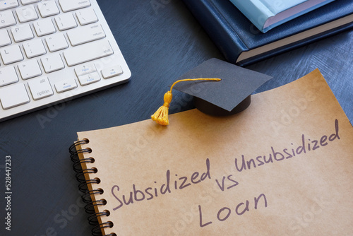 Sign Subsidized vs unsubsidized student loan and graduation cap.