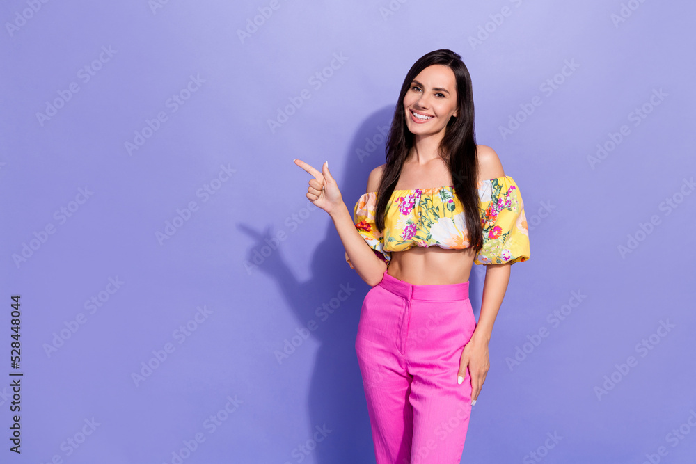 Photo of pretty adorable girl indicate finger empty space blank isolated on violet color background Photo of pretty adorable girl indicate finger empty space blank isolated on violet color background