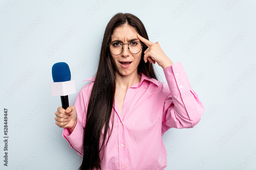 Young caucasian tv presenter woman isolated on blue background showing a disappointment gesture with forefinger. Young caucasian tv presenter woman isolated on blue background showing a disappointment gesture with forefinger.