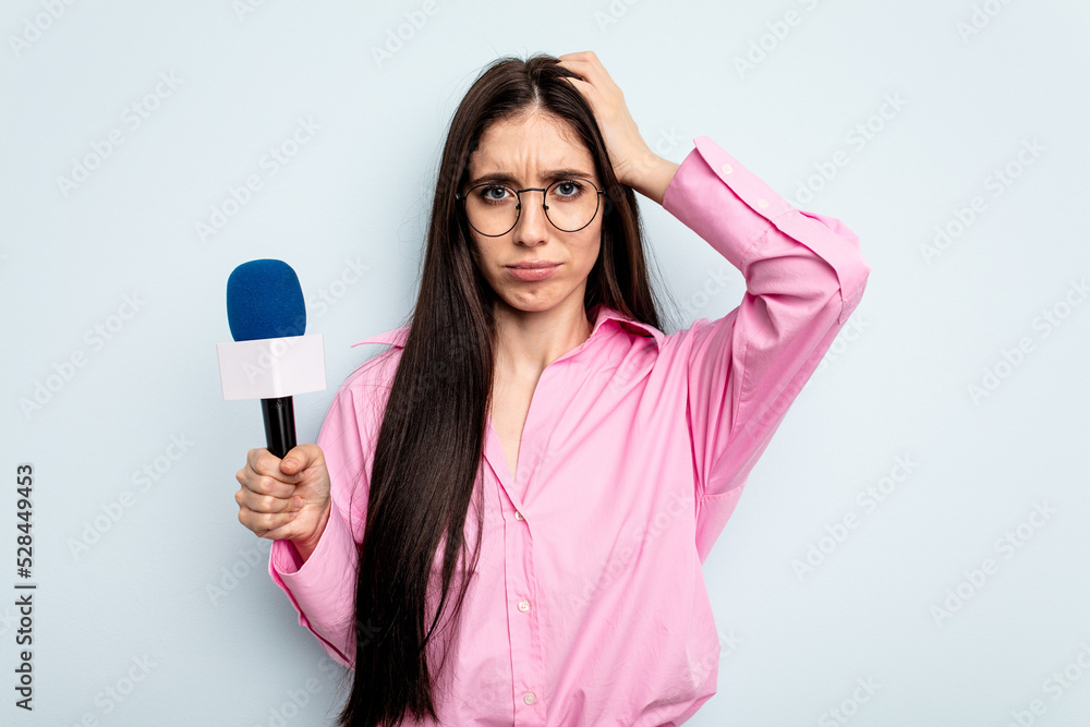 Young caucasian tv presenter woman isolated on blue background being shocked, she has remembered important meeting. Young caucasian tv presenter woman isolated on blue background being shocked, she has remembered important meeting.