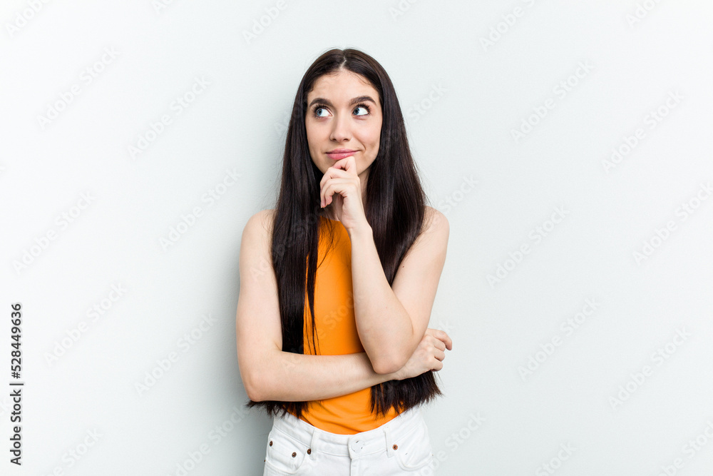 Young caucasian woman isolated on white background thinking and looking up, being reflective, contemplating, having a fantasy. Young caucasian woman isolated on white background thinking and looking up, being reflective, contemplating, having a fantasy.