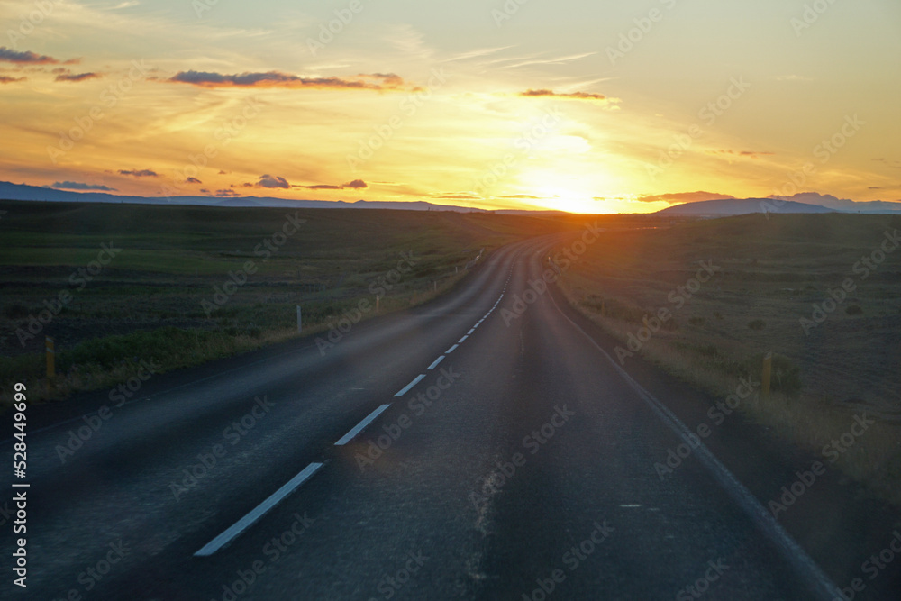 Driving a car, sunset sky