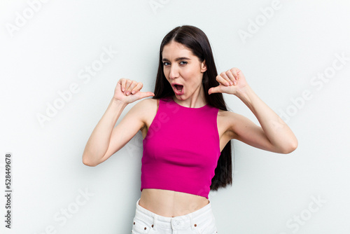 Young caucasian woman isolated on white background feels proud and self confident, example to follow.