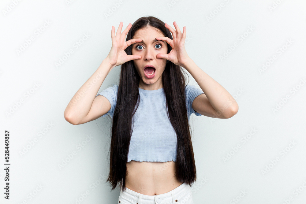 Young caucasian woman isolated on white background keeping eyes opened to find a success opportunity. Young caucasian woman isolated on white background keeping eyes opened to find a success opportunity.