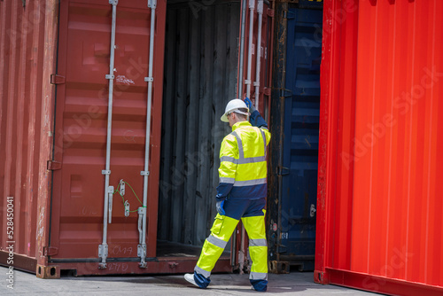 Cargo container worker checking and control loading Containers box in warehouse