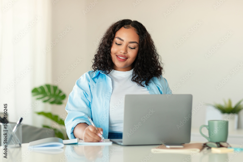 African American Lady Using Laptop Taking Notes Working In Office African American Lady Using Laptop Taking Notes Working In Office