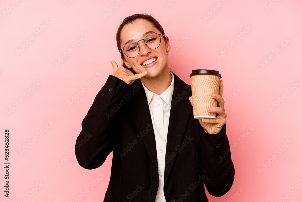 Young business caucasian woman holding take away coffee isolated on pink background showing a mobile phone call gesture with fingers. Young business caucasian woman holding take away coffee isolated on pink background showing a mobile phone call gesture with fingers.