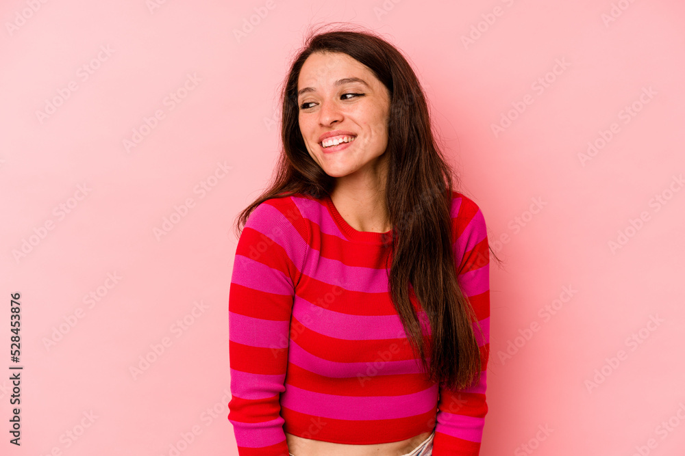Young caucasian woman isolated on pink background laughs and closes eyes, feels relaxed and happy. Young caucasian woman isolated on pink background laughs and closes eyes, feels relaxed and happy.