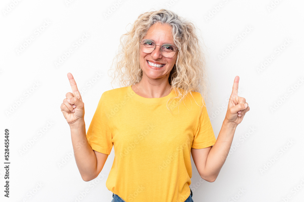 Middle age caucasian woman isolated on white background indicates with both fore fingers up showing a blank space. Middle age caucasian woman isolated on white background indicates with both fore fingers up showing a blank space.