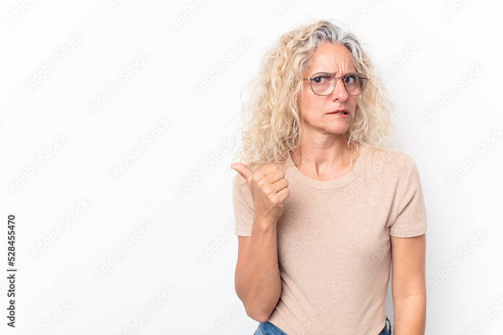 Middle age caucasian woman isolated on white background shocked pointing with index fingers to a copy space. Middle age caucasian woman isolated on white background shocked pointing with index fingers to a copy space.