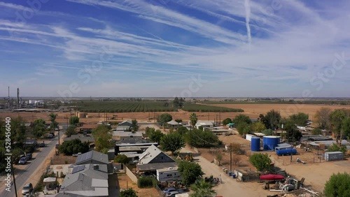 Wide panning aerial shot of a poor neighborhood in rural Central California. 4K photo