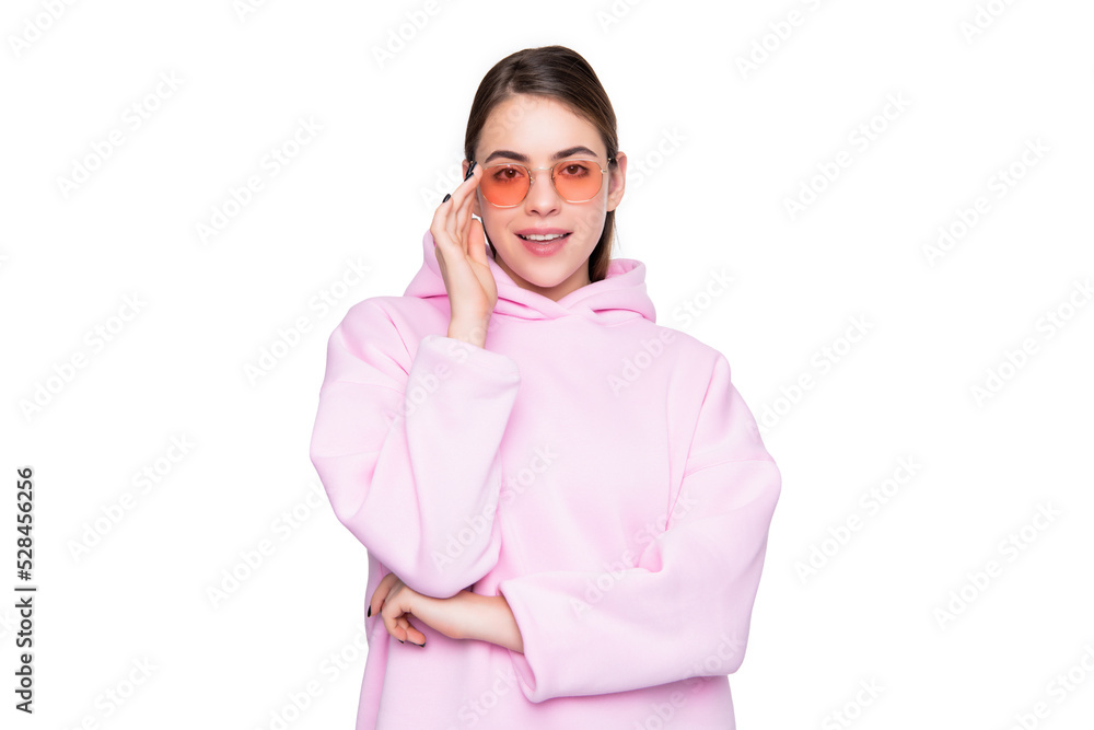 Happy young woman in casual pink hoodie adjusting glasses isolated on white, girl