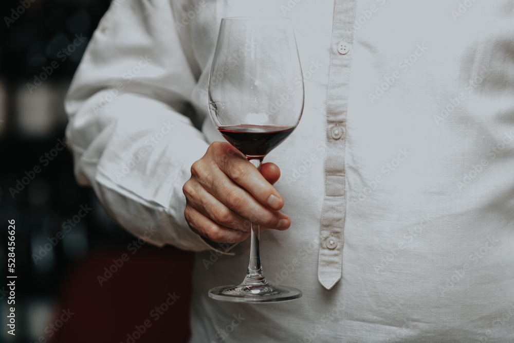 Red wine by the glass at a tasting of white, rosé and red wines that celebrates friendship and joy at the highest level with your best friends on a weekend evening full of people from social media. Red wine by the glass at a tasting of white, rosé and red wines that celebrates friendship and joy at the highest level with your best friends on a weekend evening full of people from social media.