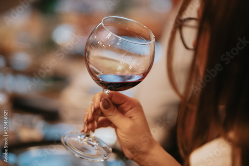 Принти на полотні Red wine by the glass at a tasting of white, rosé and red wines that celebrates friendship and joy at the highest level with your best friends on a weekend evening full of people from social media