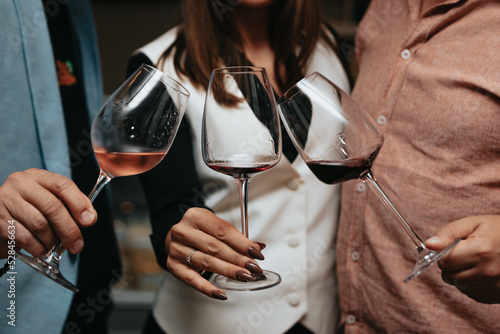 Red wine by the glass at a tasting of white, rosé and red wines that celebrates friendship and joy at the highest level with your best friends on a weekend evening full of people from social media.