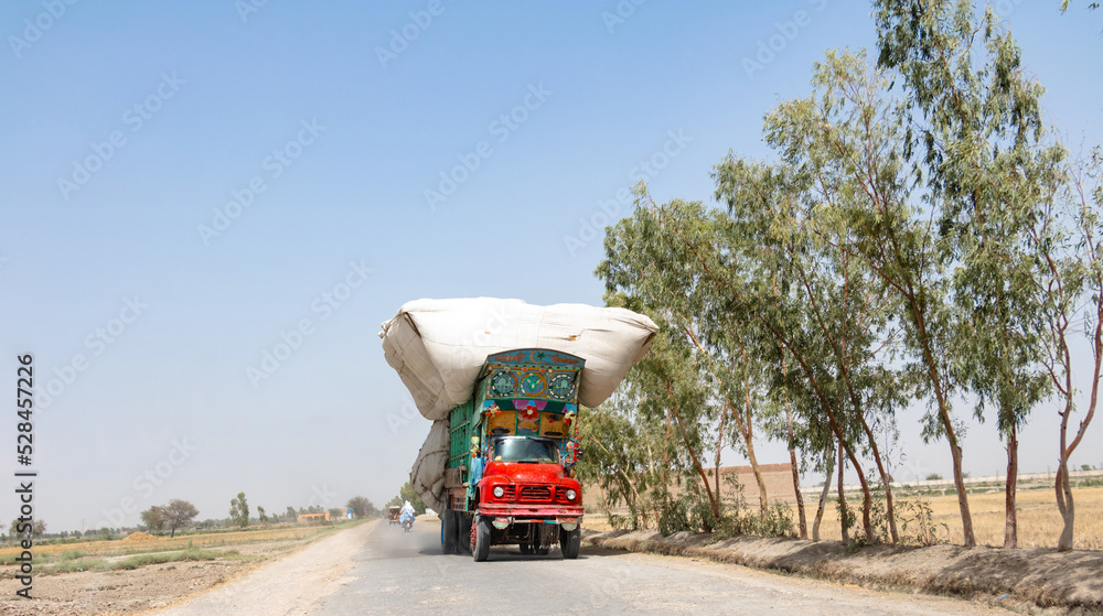 overload truck running on the road and could dangerous for other vehicles 