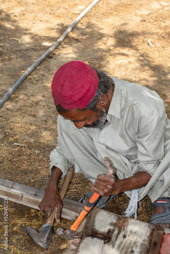 a carpenter is working and repairing a wooden door 