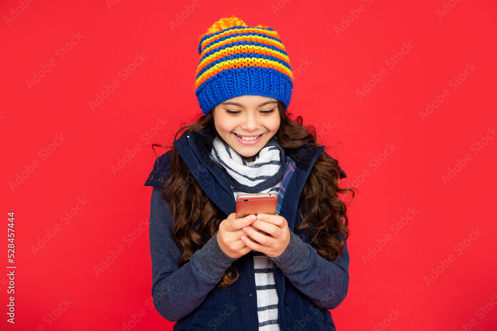 portrait of child blogging with phone. express positive emotion. greeting with winter holidays. portrait of child blogging with phone. express positive emotion. greeting with winter holidays.