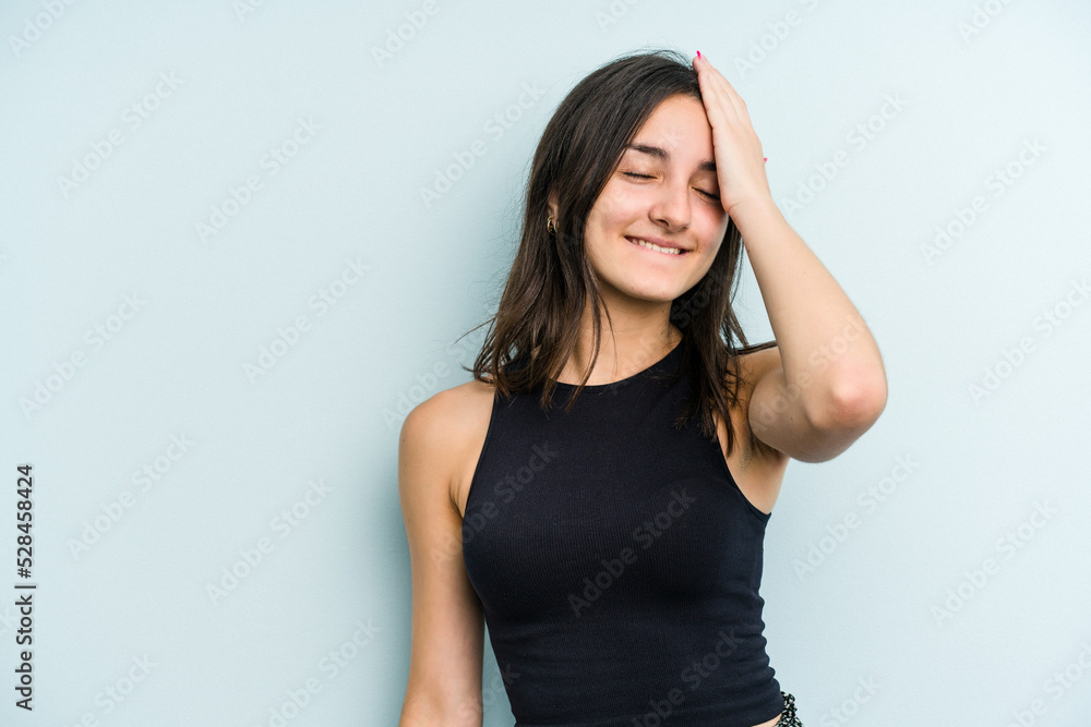 Young caucasian woman isolated on blue background laughing happy, carefree, natural emotion. Young caucasian woman isolated on blue background laughing happy, carefree, natural emotion.