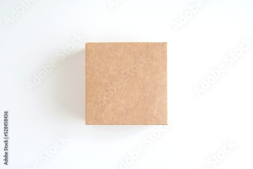 Small square cardboard box mockup for sticker, label or product presentation, blank box on white background. © IndrePau