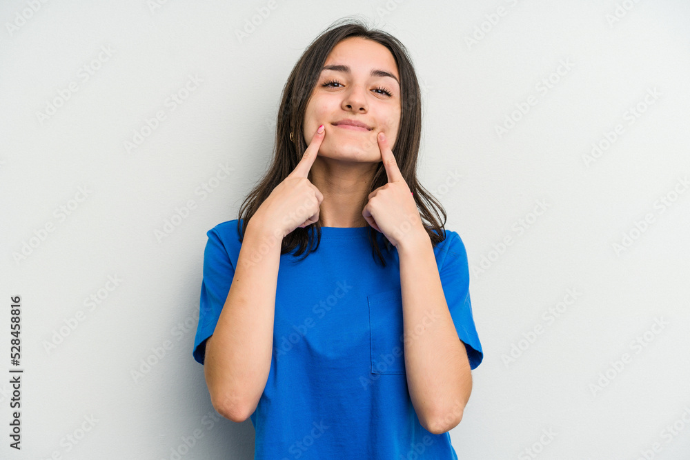 Young caucasian woman isolated on white background smiles, pointing fingers at mouth. Young caucasian woman isolated on white background smiles, pointing fingers at mouth.