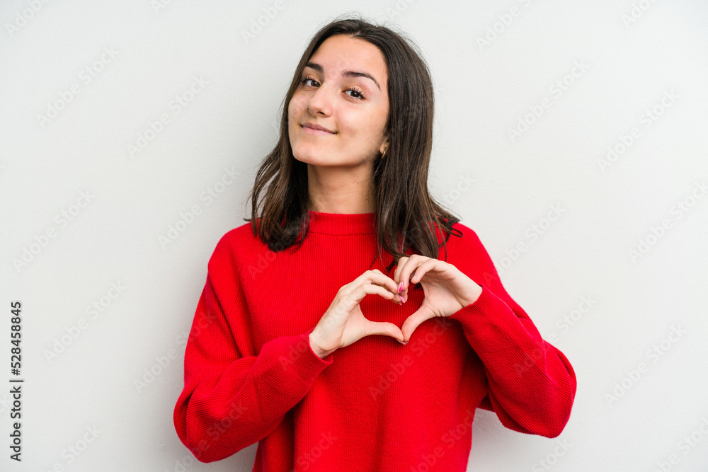 Young caucasian woman isolated on white background smiling and showing a heart shape with hands. Young caucasian woman isolated on white background smiling and showing a heart shape with hands.