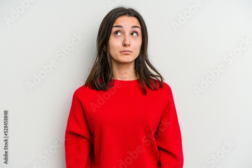Young caucasian woman isolated on white background blows cheeks, has tired expression. Facial expression concept.