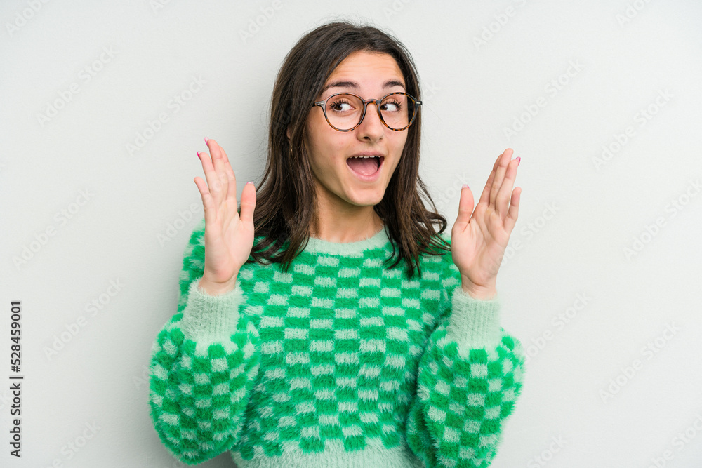 Young caucasian woman isolated on white background receiving a pleasant surprise, excited and raising hands. Young caucasian woman isolated on white background receiving a pleasant surprise, excited and raising hands.