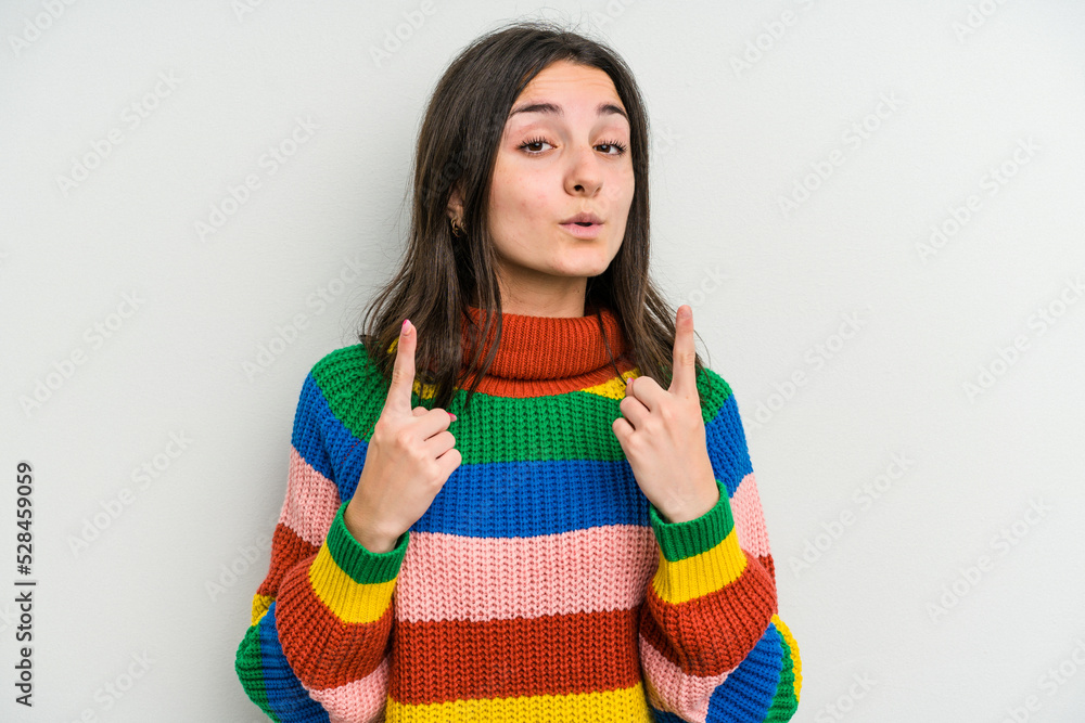 Young caucasian woman isolated on white background pointing upside with opened mouth. Young caucasian woman isolated on white background pointing upside with opened mouth.