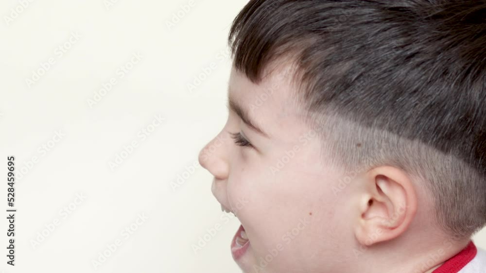 kid using spray for sore throat red neck pain virus infection.close up side or front view cute little boy spray solution for throat treatment.mother and.child closes tightly the eyes.isolated beige kid using spray for sore throat red neck pain virus infection.close up side or front view cute little boy spray solution for throat treatment.mother and.child closes tightly the eyes.isolated beige