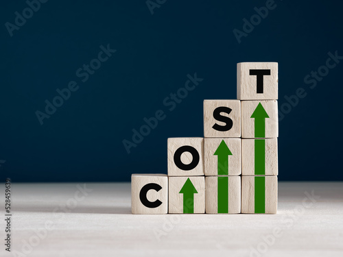 Cost increase and inflation concept. The word cost on wooden cubes with arrows going up.