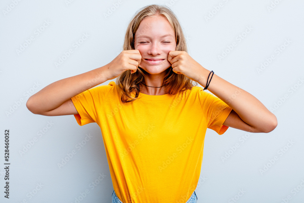 Caucasian teen girl isolated on blue background doubting between two options. Caucasian teen girl isolated on blue background doubting between two options.