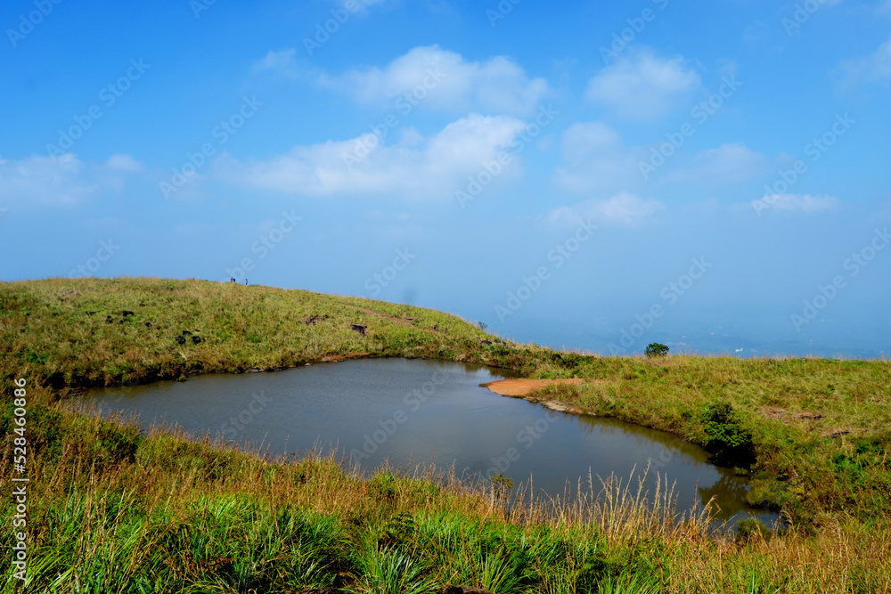 landscape with heart shaped pond and blue sky