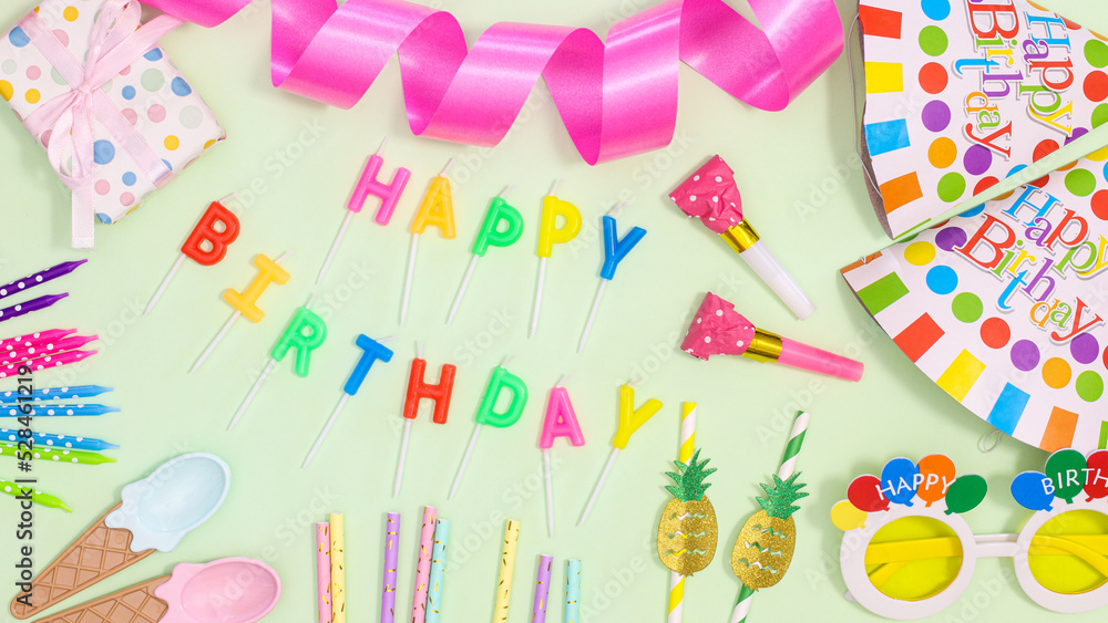 Birthday party background with party accessories on pastel greentheme. Flat lay