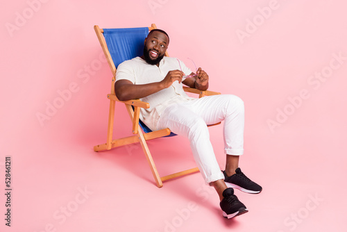 Fotografering Photo of funny dreamy guy dressed white shirt sitting deck chair looking empty s
