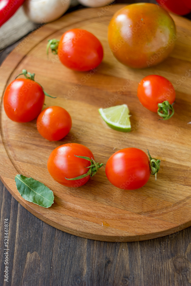 Few Cherry tomatoes on a wooden board Few Cherry tomatoes on a wooden board