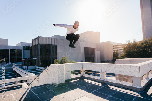 Bild auf Leinwand Athletic man practicing parkour tricking and freerunning