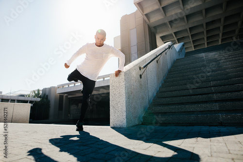 Fit urban guy performing a wall spin