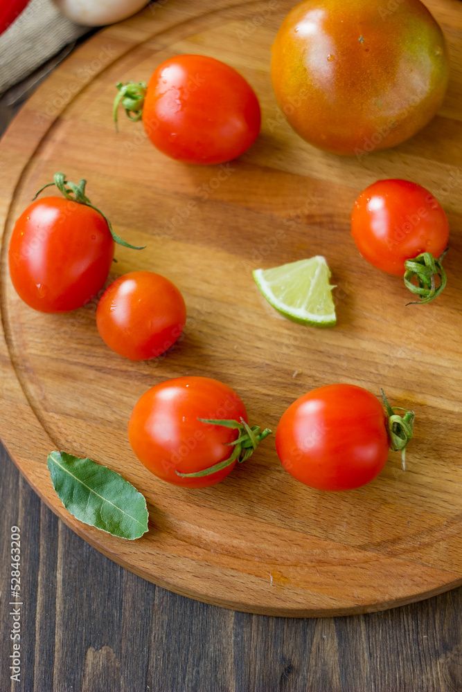 Few Cherry tomatoes on a wooden board Few Cherry tomatoes on a wooden board