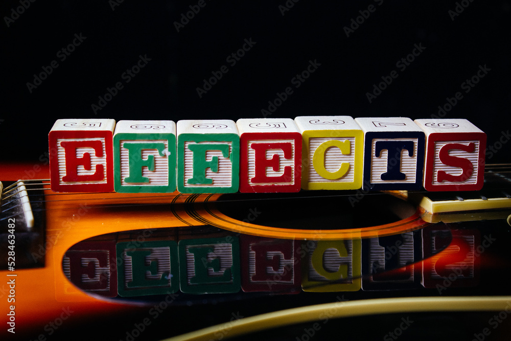 Obraz premium Word or phrase Effects made with letter cubes, standing on guitar.
