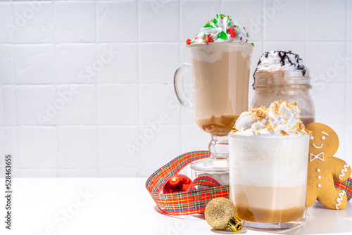 Autumn winter coffee latte set, Autumn winter coffee drink assortment with various topping - gingerbread caramel, mocha chocolate, candy cane peppermint latte in different cups, on white background